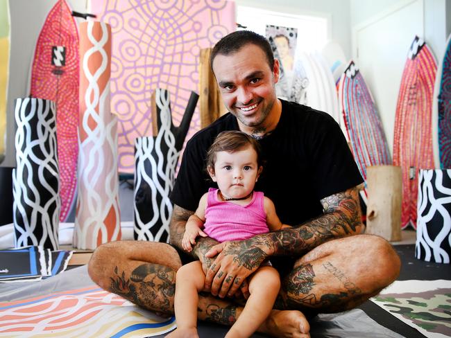 The Australian. Up and coming young indigenous artist Otis Hope Carey pictured in his home studio in Coffs Harbour with his 1yr old daughter Elky