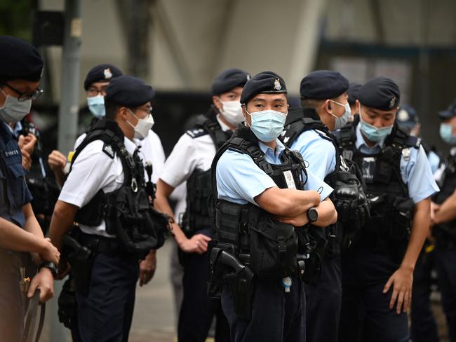 Police keep watch outside a court in Hong Kong on February 6, 2023 as the trial of 47 of Hong Kongâs most prominent pro-democracy figures begins in the largest prosecution under a national security law that has crushed dissent in the city. (Photo by Peter PARKS / AFP)