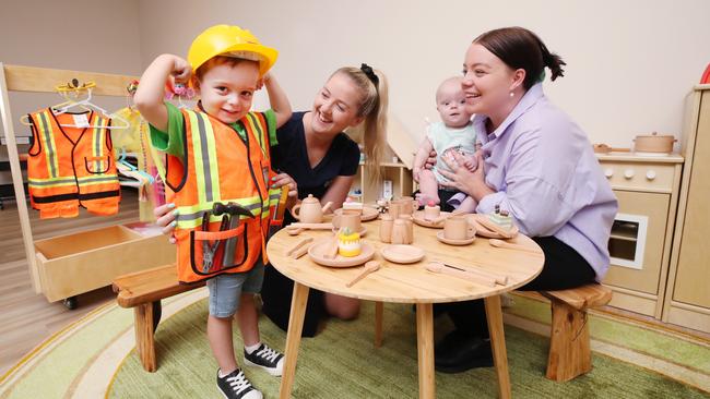 Four-year-old Hudson Lamb shows off his skills to Centre Director Kathryn Watson, sister Remi Lamb (five months) and mother Bella Lamb at Edge Early Learning Centre at Pimpama Village. Picture: Glenn Hampson.