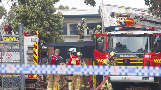 Firefighters clean-up the scene of the Heatherwood fire. Picture: David Crosling