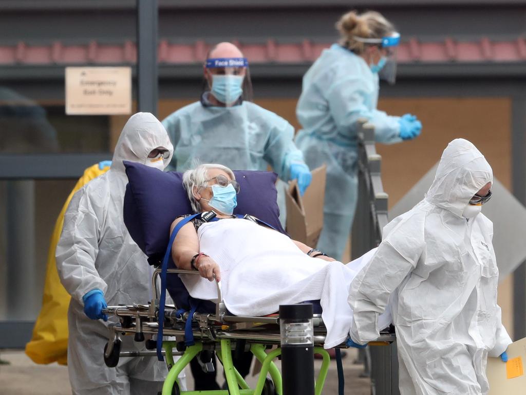 Residents are taken to waiting ambulances at St Basil’s nursing home in Fawkner, Melbourne. The nursing home is one of many in Melbourne which have a COVID-19 outbreak. Picture: David Crosling