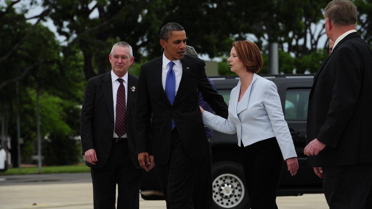 Then-Prime Minister Julia Gillard walks away arm in arm with then-US President Barack Obama after arriving in Darwin in 2011, the last visit from a US president to the Top End.