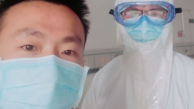 Shen Wufu, 32, with a medical worker at a hospital in the southern city of Shantou after being infected by the coronavirus. Picture: Shen Wufu/The Wall Street Journal