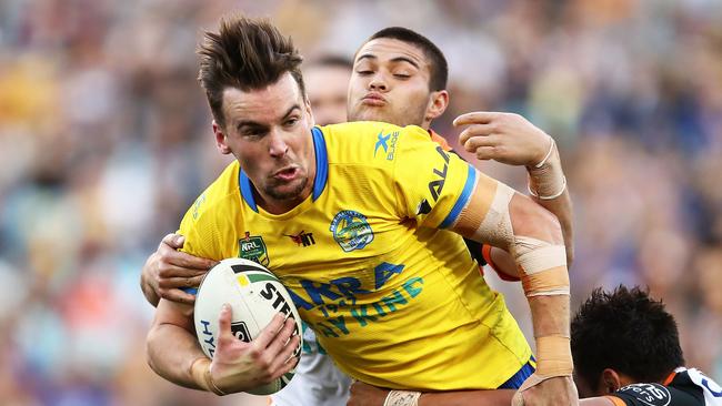 SYDNEY, AUSTRALIA — JULY 23: Clint Gutherson of the Eels is tackled by the Tigers defence during the round 20 NRL match between the Wests Tigers and the Parramatta Eels at ANZ Stadium on July 23, 2017 in Sydney, Australia. (Photo by Brendon Thorne/Getty Images)