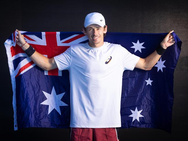 ***CONTACT HERALD SUN PIC DESK BEFORE USING*** MELBOURNE, JANUARY 11, 2024: Alex de Minaur poses with the Australian flag ahead of the Australian Open. Picture: Mark Stewart