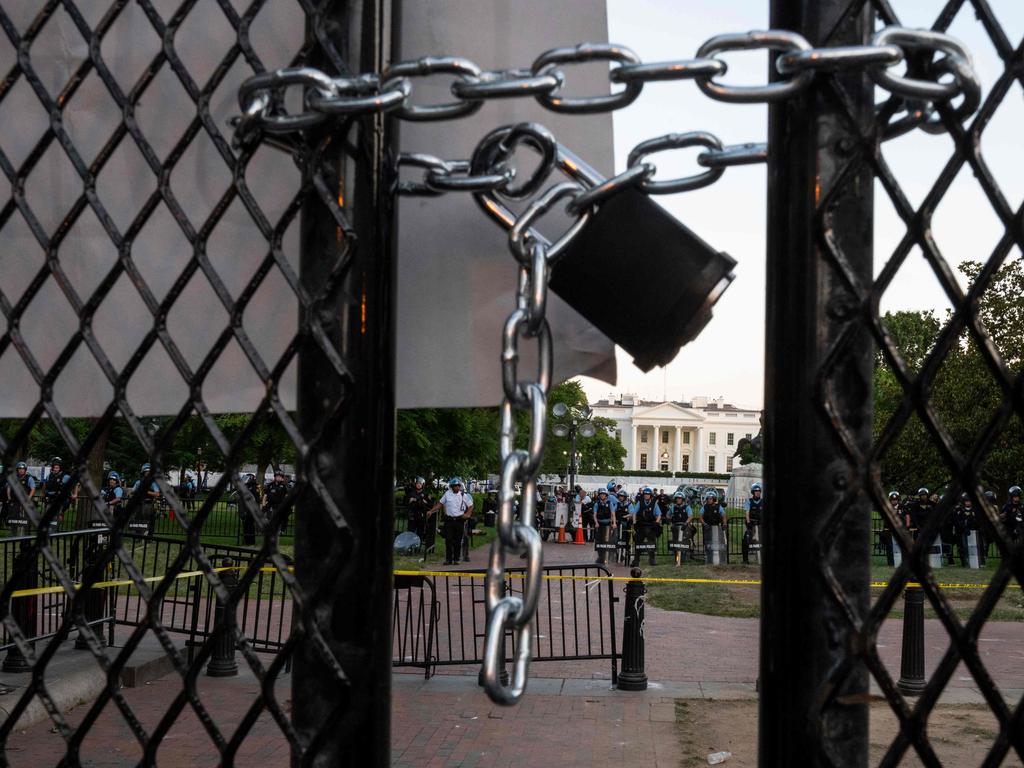 A locked padlock keeps a metal fence recently erected in front of the White House. Picture: Logan Cyrus