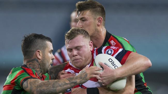 Rooster Drew Hutchison is crucnched by the Rabbitohs defence