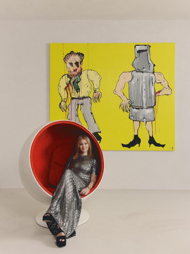 Eva sits in her Ball Chair by Finnish designer Eero Aarnio, Eva Galambos, in front of Adam Cullen’s, Untitled (Ned Kelly), 2007. Picture: Michael Comninus