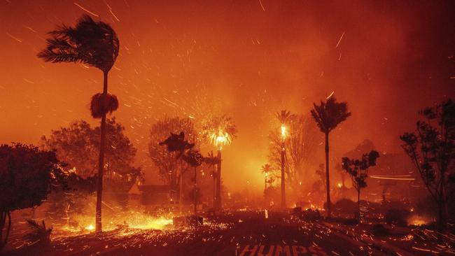 The Palisades Fire ravages a neighbourhood amid high winds. Picture: AP