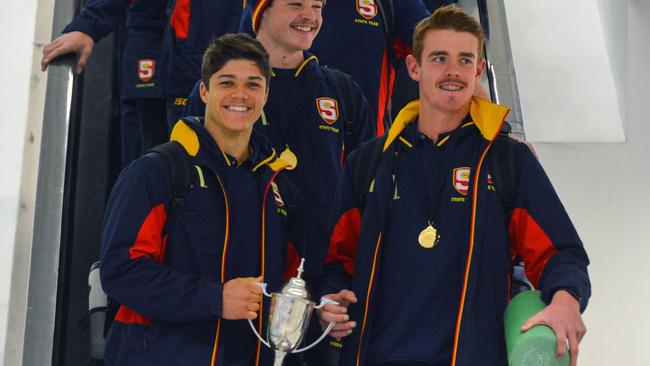 SA U18 championship players Tom Lewis and Jez McLennan lead the team at Adelaide Airport. Picture: AAP Image/ Brenton Edwards