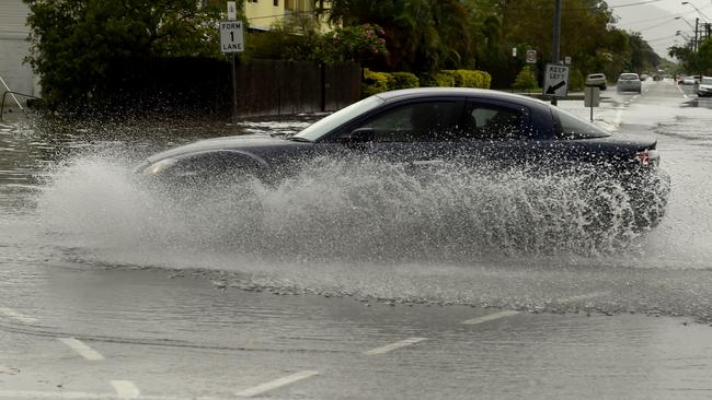 Wet weather in Townsville. A car goes through the flooded intersection of Hugh Street and Palmerston Street, Gulliver. Picture: Evan Morgan