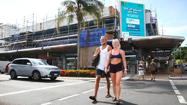 Swedish tourists Sarah Nordin and August Ovall walks past a building currently undergoing a million dollar renovation on the corner of Abbott and Spence Streets. PICTURE: BRENDAN RADKE