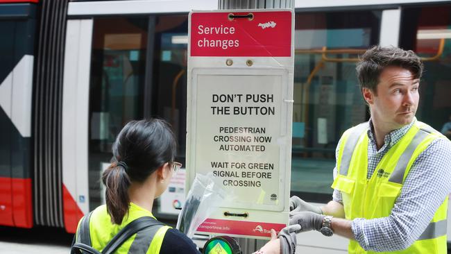 Signs dissuade pedestrians from pressing Sydney’s buttons. Picture: John Feder