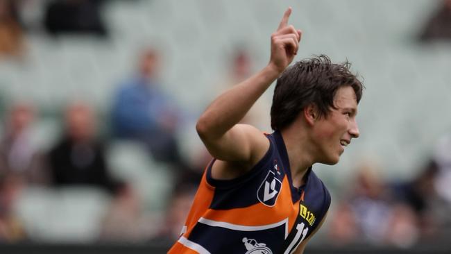 Calder Cannons player Dylan Joyce salutes the sky after kicking a goal.