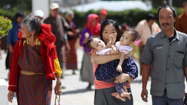 Mum Bhumchu with Nima and Dawa, and dad Sonam Tshering, at the Buddhist temple in Thimphu. Picture: Alex Coppel