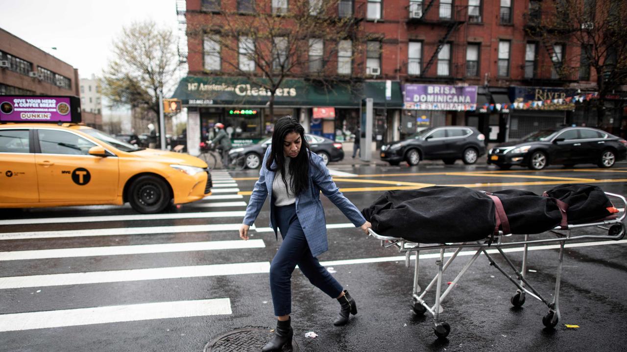 Alisha Narvaez Manager at International Funeral &amp; Cremation Services transports a body to the funeral home on April 24, 2020 in the Harlem neighbourhood of New York City. Picture: Johannes Eisele / AFP.