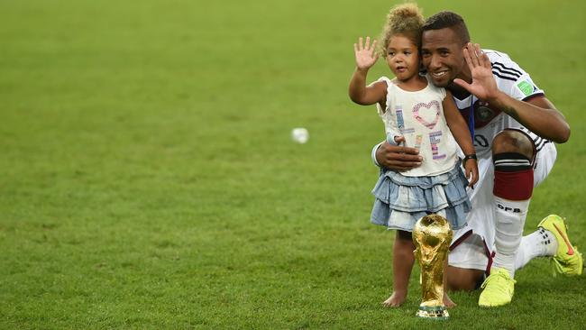 Jerome Boateng poses for a photo with his daughter after winning the World Cup in 2014.