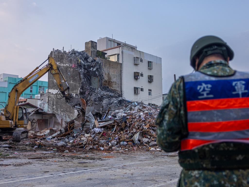 Rescue teams demolish a collapsed building following the earthquake in Taiwan. Picture: Getty Images