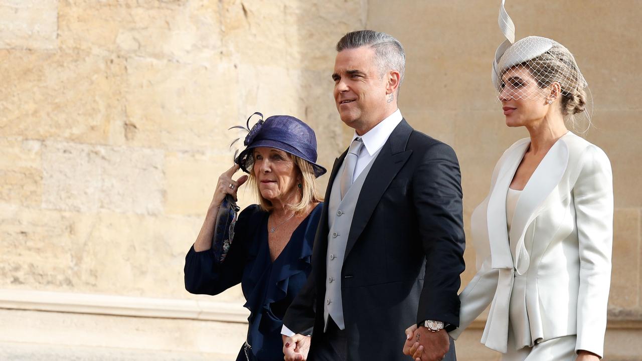 That’s his mother-in-law on the left — at one point her hat blew off and he DIDN'T HELP HER GRAB IT Picture: AFP