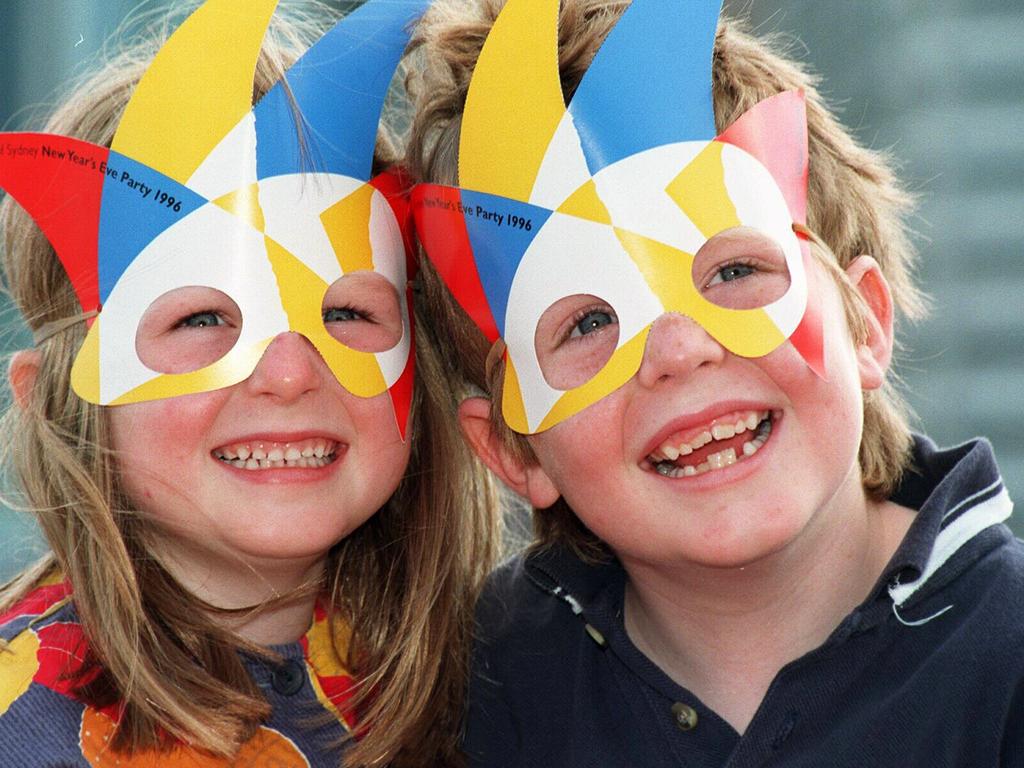 Kaitlin Moylan and brother Jack of Duffy's Forest wearing 1996 New Year’s Eve Mask. Photo: Courier Mail archives