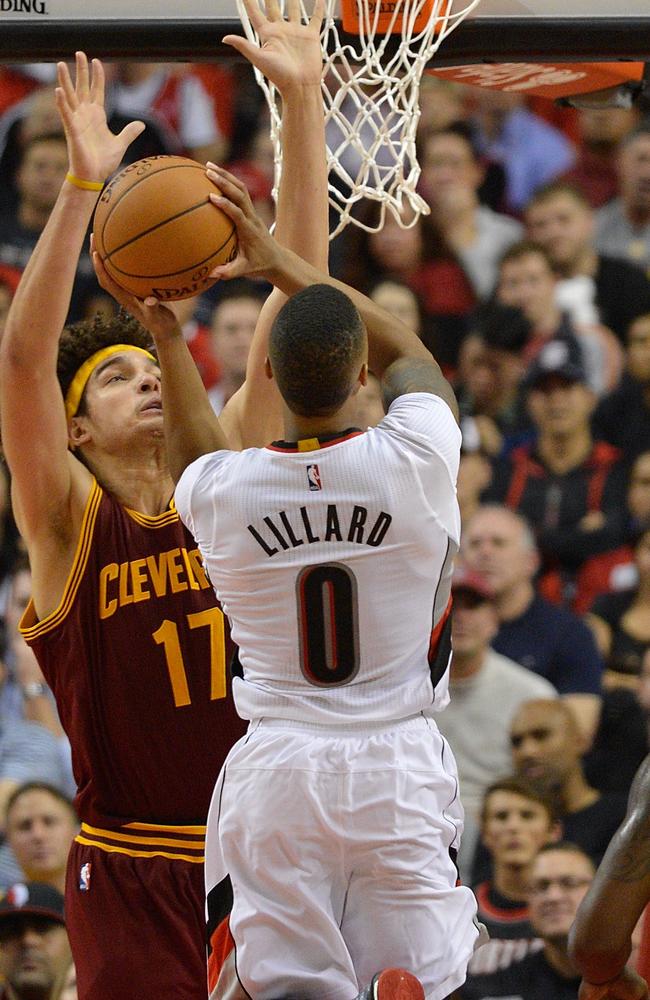Damian Lillard of the Portland Trail Blazers drives to the basket on Anderson Varejao of the Cleveland Cavaliers.