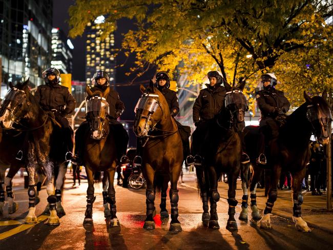 Mounted police form outside a debate featuring former White House chief strategist Steve Bannon and conservative commentator David Frum in Toronto. Picture: AP