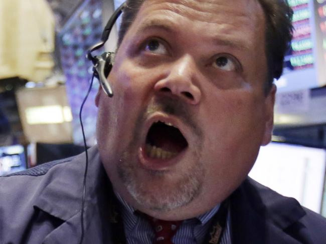 FILE - In this Monday, Aug. 24, 2015, file photo, trader John Santiago, center, works on the floor of the New York Stock Exchange. Conversations Monday with roughly a dozen everyday Americans suggest that people generally expect stock prices to rebound, just as they have after previous swoons. (AP Photo/Richard Drew, File)