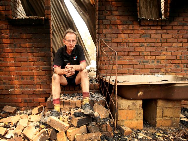 Daily Telegraph. Houses lost in the Nana Glen bushfire. Mechanic Warren Smith at his destroyed home on Ellems Quarry Rd, Nana Glen. Picture Nathan Edwards.