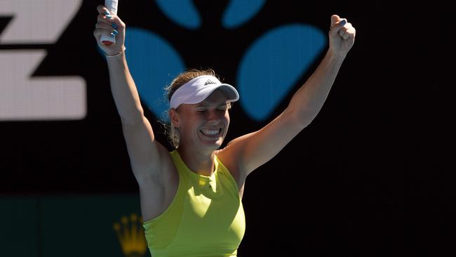 Caroline Wozniacki raises her arms in jubilation after surviving a huge scare against Jana Fett on Rod Laver Arena. Picture: AAP