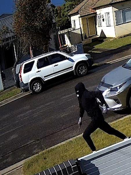 The CCTV footage shows a man – dressed in all black and wearing a balaclava – running towards the car.