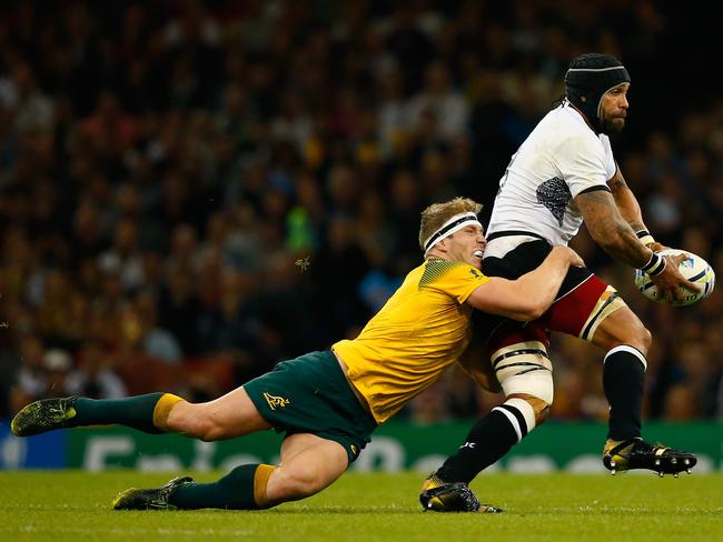 CNetani Talei of Fiji is tackled by David Pocock of Australia.