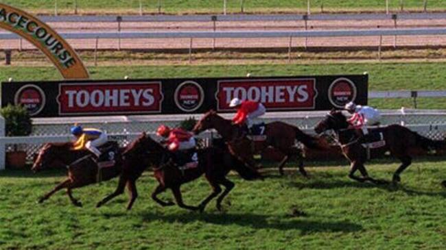 What Can I Say, ridden by Chris Munce, wins the Warwick Stakes on a heavy track at Warwick Farm in 1998. That’s turf great Might And Power on the right.