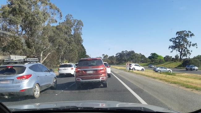 Cars use the freeway slip lane designated for emergency vehicles to avoid the delay on the South-Eastern Freeway.