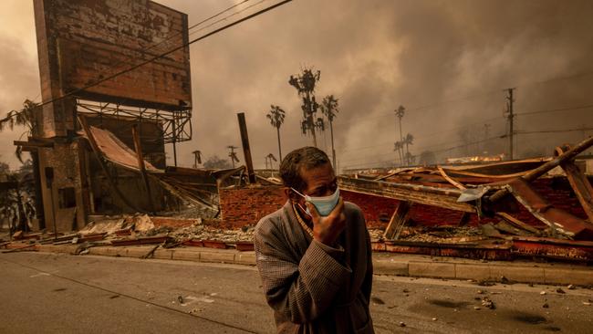 A man walks past a fire-ravaged business after the Eaton fire swept through Altadena. Picture: AP