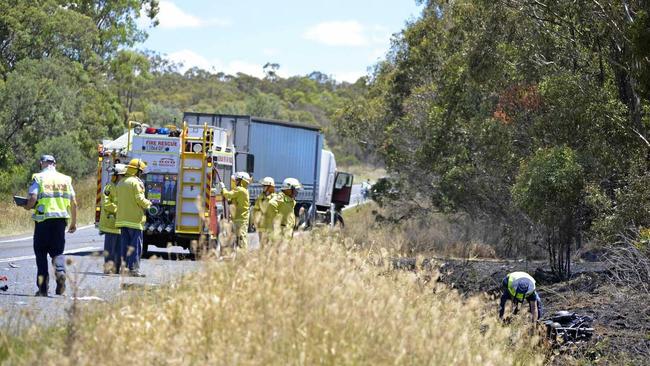 Emergency services on the scene of a fatal collision between a semi trailer and bike on the New England Highway. Picture: Gerard Walsh