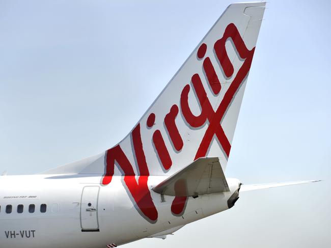 Virgin Australia aircraft seen at Sydney International Airport, Sydney, Friday, Aug. 12, 2016. International air passengers are being warned of potential disruption and delays when union members in the Department of Immigration and Border Protection strike for 24 hours. (AAP Image/Joel Carrett) NO ARCHIVING