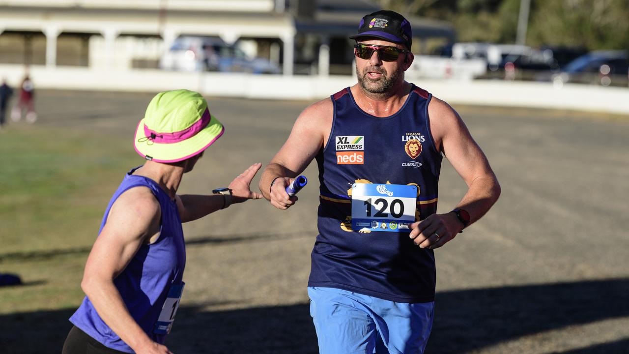Dan Fraser hands the baton to his wife Nat Fraser for the Hot Steppers in the 40 for Fortey relay at Toowoomba Showgrounds, Sunday, June 8, 2025. Picture: Kevin Farmer