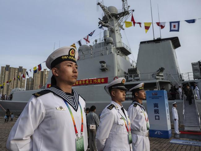 Chinese sailors stand at attention next to the destroyer Shijiazhuang. Picture: Kevin Frayer/Getty Images