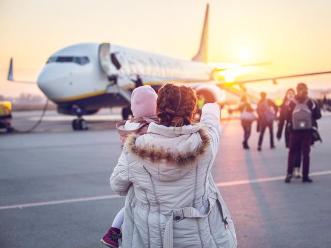 ESCAPE: Travel story on Frequent Flyer credits and airline loyalty point programs. By Lisa Mayoh. iStock31 years old woman with her daughter at the airport near the plane. They are traveling to another country for holiday