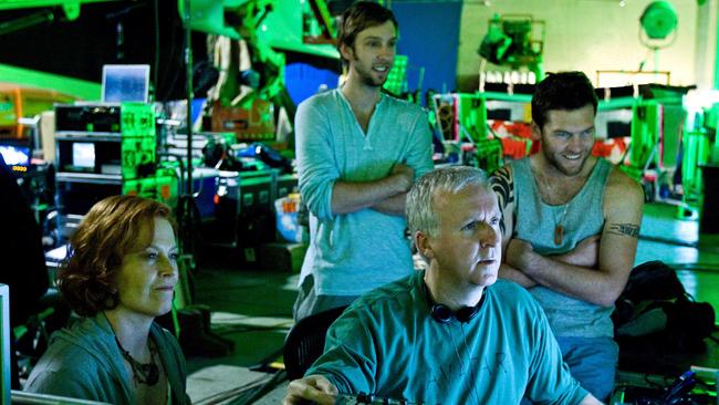 James Cameron reviews a scene with actors Sigourney Weaver, Joel David Moore and Sam Worthington during the filming of Avatar.