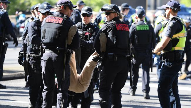 A protester is taken away in Thursday’s protest chaos. Picture: AAP Image/Erik Anderson