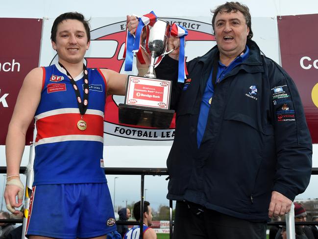 Keilor's Dylan Joyce and coach Mick McGuane hoist the 2016 EDFL premiership cup. Picture: Kylie Else