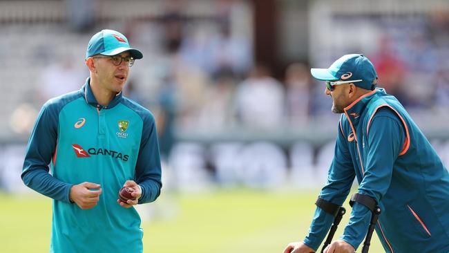 Nathan Lyon (R) on crutches, chatting to teammate Todd Murphy on a sunny day at Lord’s. Picture: Getty