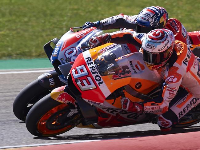 Spain's rider Marc Marquez of the Repsol Honda Team, front, steers his motorcycle followed by Italian rider Andrea Dovizioso of the Ducati Team at the MotoGP race during the Aragon Motorcycle Grand Prix at the Aragon Motorland racetrack in Alcaniz, Spain, Sunday, Sept. 23, 2018. (AP Photo/Jose Breton)