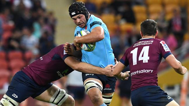 Waratahs forward Michael Wells tries to bust through the Reds defence. Picture: AAP