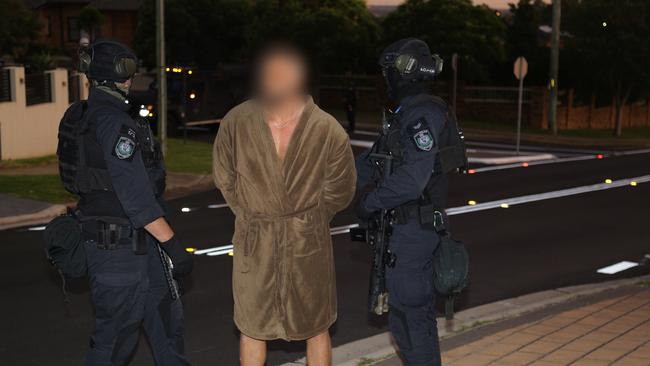 A man is arrested in a bath robe at his home in Casula by Strike Force Shaughnessy. Picture: NSW Police