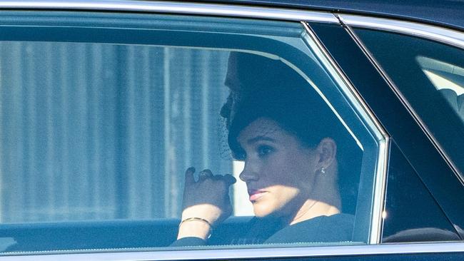 LONDON, ENGLAND - SEPTEMBER 14: Prince Harry, Duke of Sussex and Meghan, Duchess of Sussex return by car to Buckingham Palace after attending a service for the reception of Queen Elizabeth II's coffin on September 14, 2022 in London, England. Queen Elizabeth II will lay in state until the early morning of her funeral. Queen Elizabeth II died at Balmoral Castle in Scotland on September 8, 2022, and is succeeded by her eldest son, King Charles III. (Photo by Arthur Edwards - WPA Pool/Getty Images)