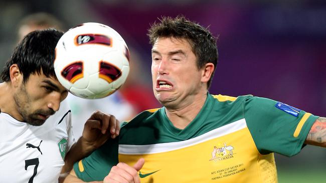 Australia's midfielder Harry Kewell (R) vies for the ball with Uzbekistan's midfielder Azizbek Haydarov during their 2011 Asian Cup semi-final football match in the Qatari capital Doha on January 25, 2011. AFP PHOTO/YASSER AL-ZAYYAT