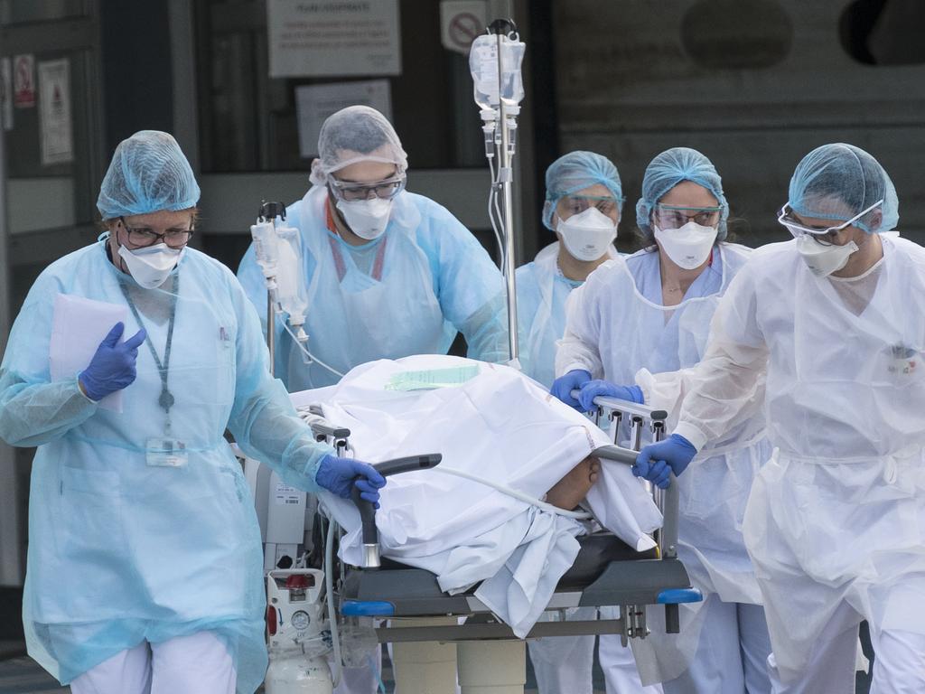 Medical staff push a patient on a gurney to a waiting medical helicopter at the Emile Muller hospital in Mulhouse, eastern France, to be evacuated on another hospital. Picture: SEBASTIEN BOZON / AFP