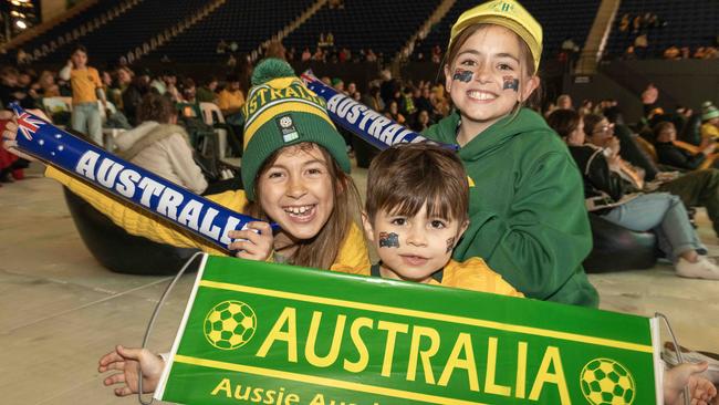 Fans Natalia 8, Zeke 5 and Lillian 10 getting ready for the Matildas vs England Semi Final at Memorial drive. Picture: NCANewsWire / Kelly Barnes